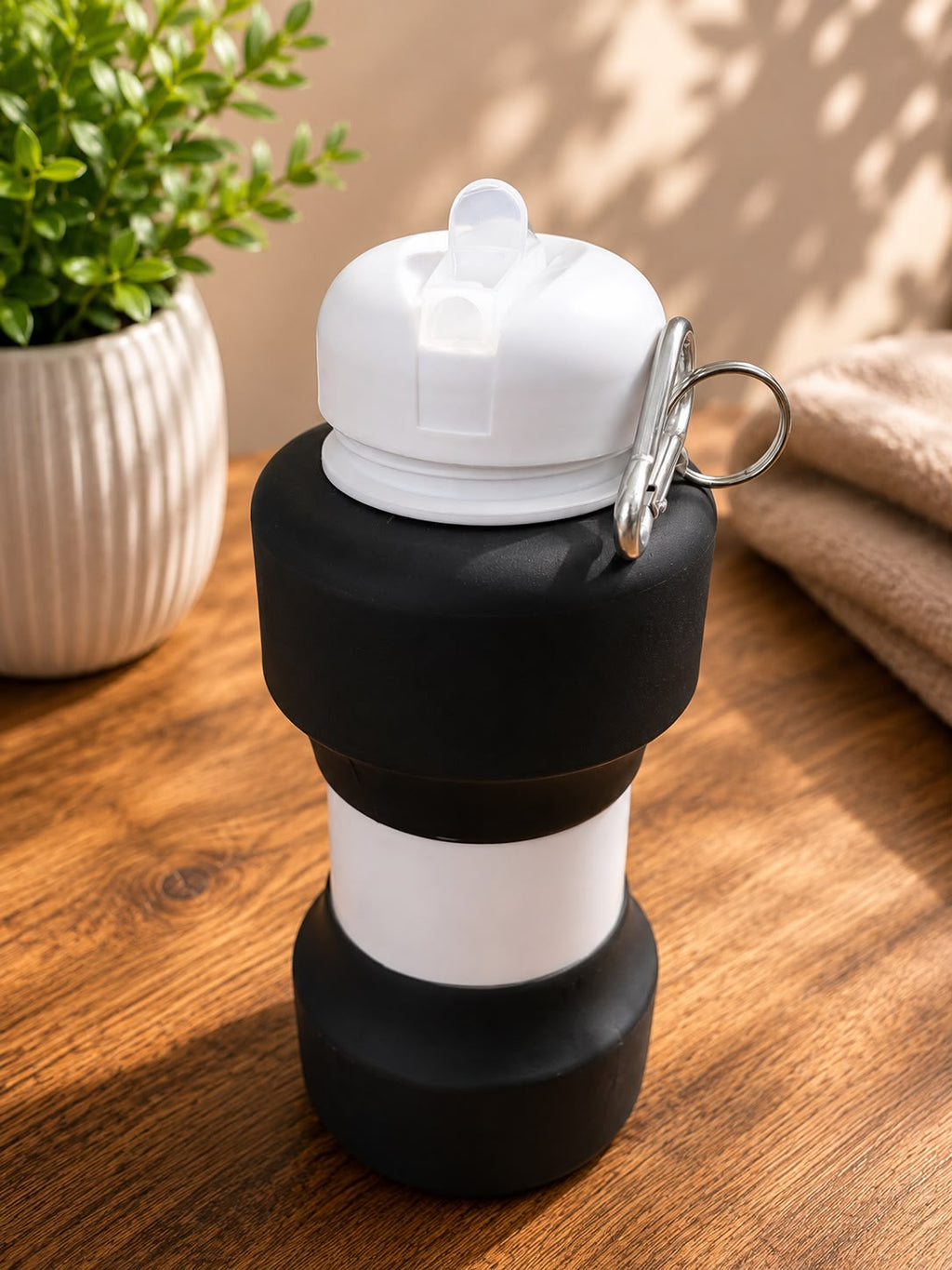 Black Foldable Water Bottle folded flat, corporate gift by Veloura Gifting